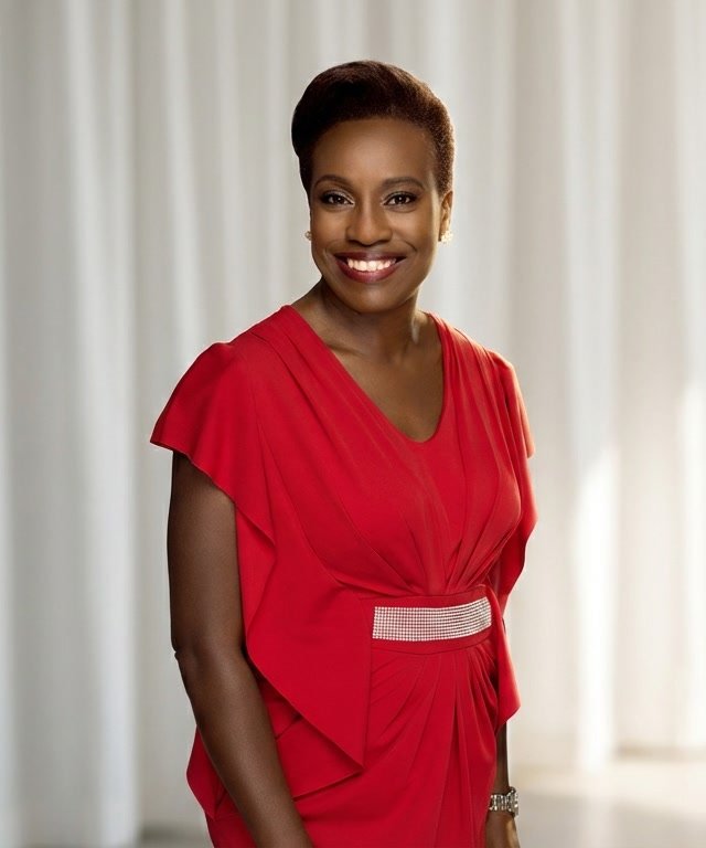 Michelle Olufeso-Nwokobia smiling in a red dress