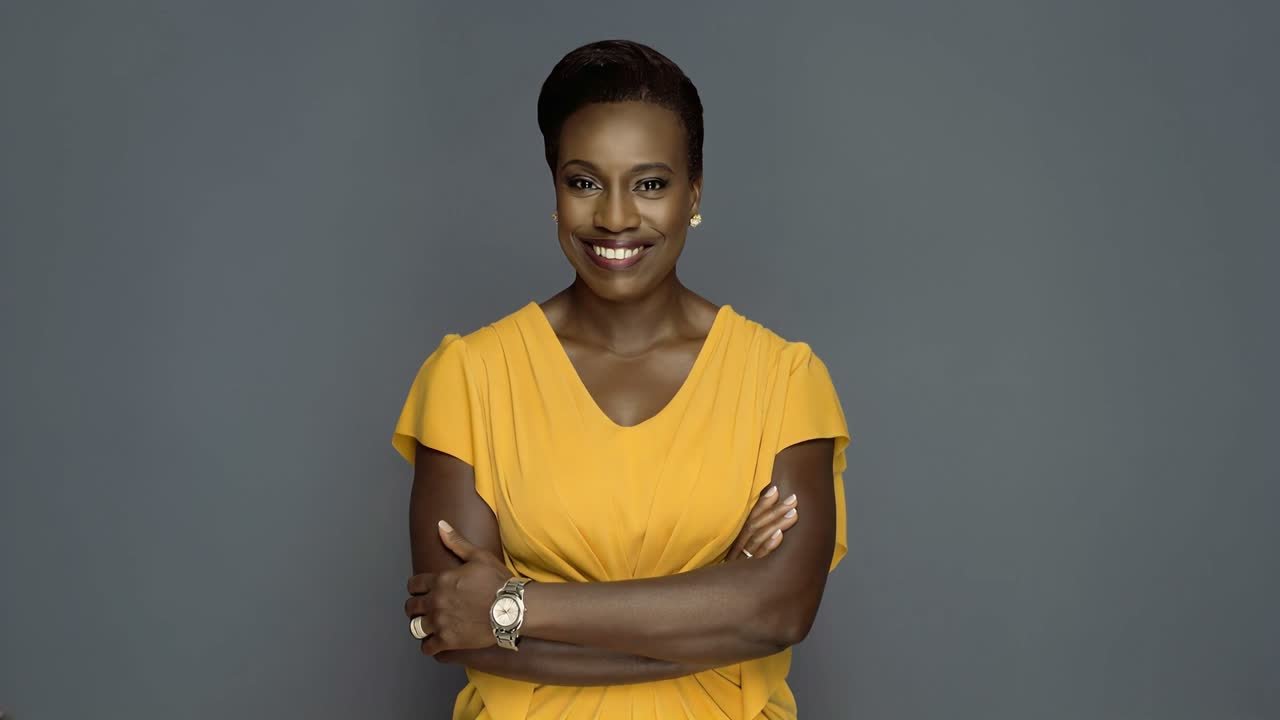 Michelle Olufeso-Nwokobia smiling in a yellow dress
